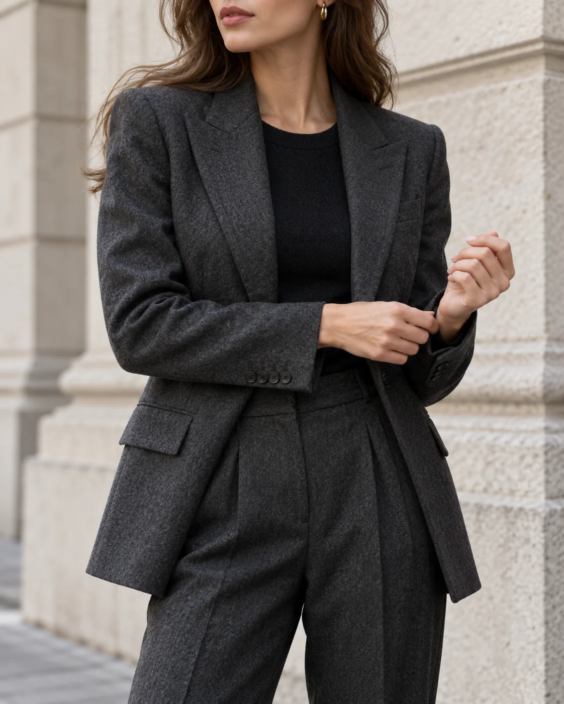 The sleeve and cuffs of a charcoal suit
